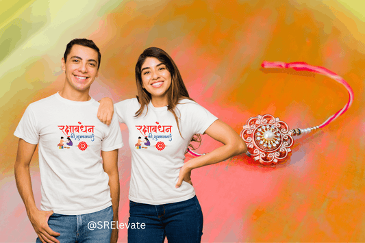 Two people wearing white t-shirts with text and a rakhi on a colorful background